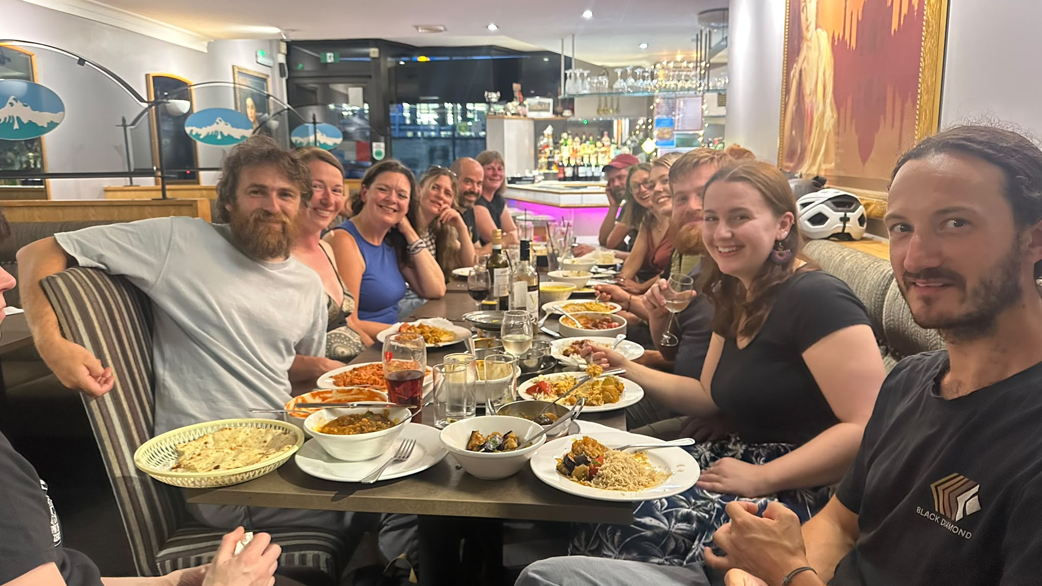 A lively table of guests enjoying dinner together