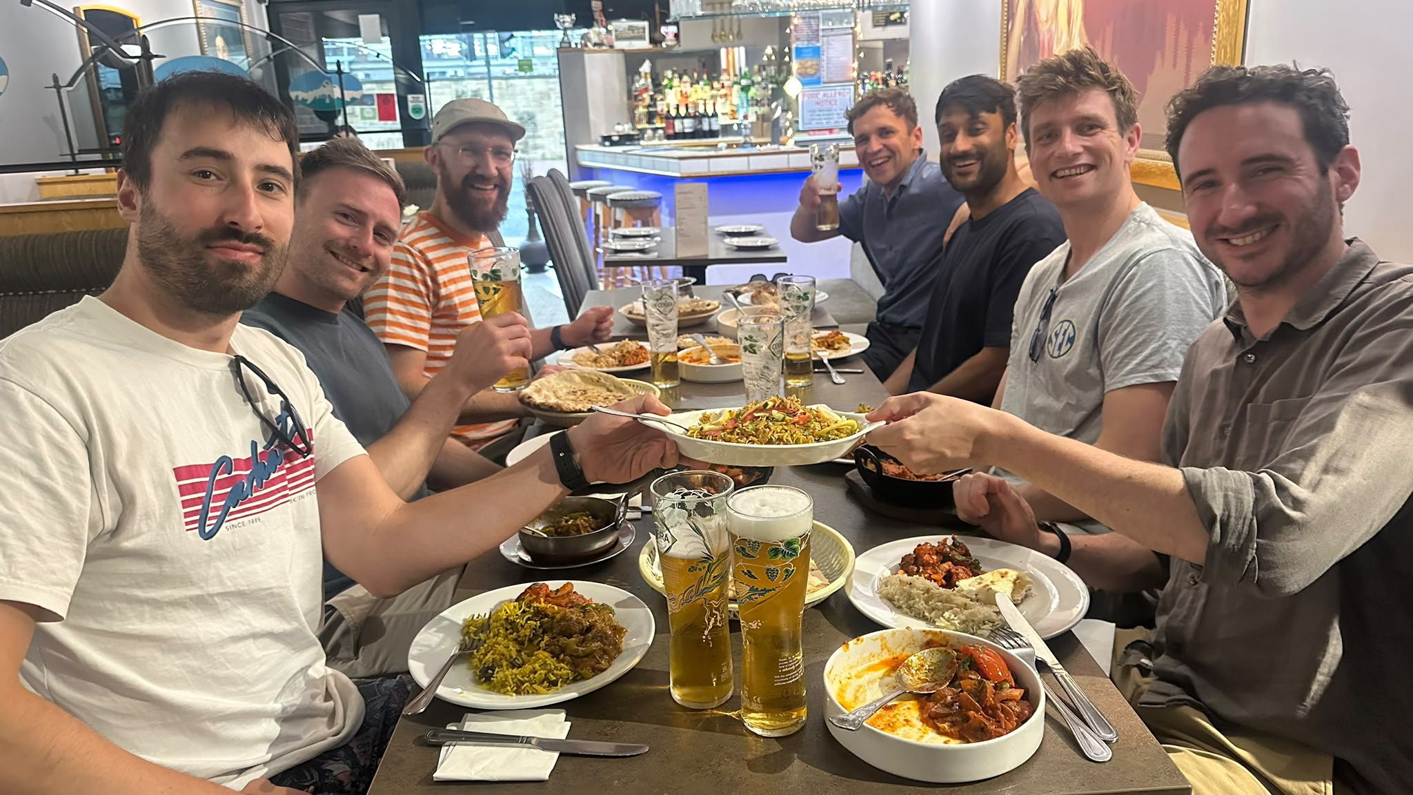 A private group of friends raising a toast over dinner